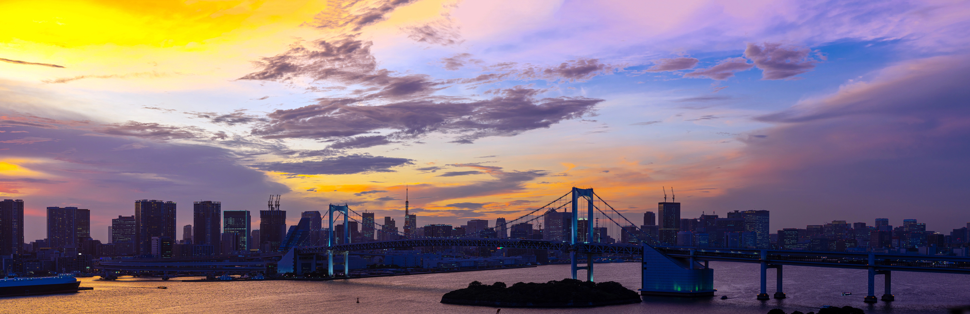 Tokyo Bay sunset with Rainbow Bridge and city skyline